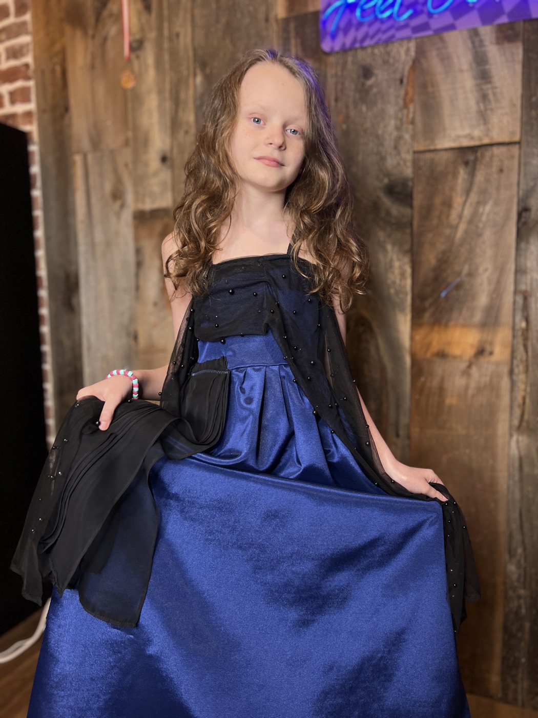 Young designer in a beaded ball gown she made