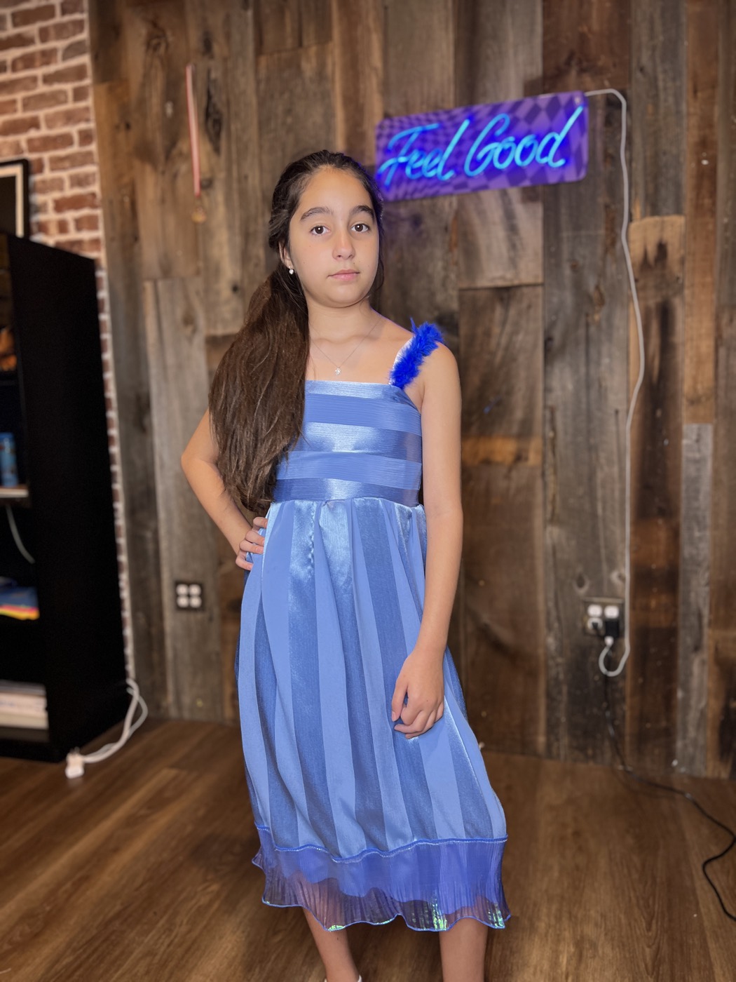Young designer in a pleated party dress she made